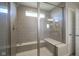 Modern shower with gray tile and glass divider, featuring a built in bench at 2237 S Copperstone Dr, New Palestine, IN 46163