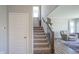 Well-lit staircase leading to the upper level, showcasing modern design and neutral decor at 2237 S Copperstone Dr, New Palestine, IN 46163