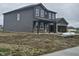 Two-story house with gray siding and brick accents on a partially landscaped lot at 2249 Oakmont Dr, Plainfield, IN 46168