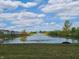 Beautiful pond with a fountain in a community with a manicured lawn and blue sky with white clouds at 2249 Oakmont Dr, Plainfield, IN 46168
