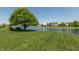 A beautiful view of the yard and a pond from the grassy lawn on a sunny day at 2325 Silver Rose Dr, Avon, IN 46123