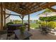 Backyard features a covered patio with hot tub, dining area, outdoor seating and lake views at 2325 Silver Rose Dr, Avon, IN 46123