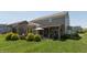 Exterior view of a house with a backyard featuring a covered patio, pergola, and greenery at 2325 Silver Rose Dr, Avon, IN 46123