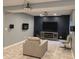 Finished basement featuring a TV, entertainment center, stylish fireplace, and modern decor at 2325 Silver Rose Dr, Avon, IN 46123