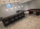 Basement bar area with seating, wet bar, modern pendant lighting, and view of the pool table at 2325 Silver Rose Dr, Avon, IN 46123