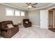 Comfortable bedroom with neutral walls, plush carpet, two armchairs and large windows at 2325 Silver Rose Dr, Avon, IN 46123