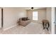 A cozy bedroom featuring a loveseat and neutral tones at 2325 Silver Rose Dr, Avon, IN 46123