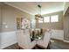 Bright dining area with a modern chandelier, seating six, and three windows for natural light at 2325 Silver Rose Dr, Avon, IN 46123