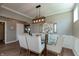 Elegant dining room with a glass-top table, six upholstered chairs, and a modern light fixture at 2325 Silver Rose Dr, Avon, IN 46123
