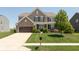 Inviting two-story home with a well-maintained lawn, complemented by a brick-accented facade and a two-car garage at 2325 Silver Rose Dr, Avon, IN 46123