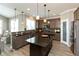 Modern kitchen featuring dark cabinets, granite countertops, stainless steel appliances, and a central island at 2325 Silver Rose Dr, Avon, IN 46123