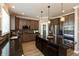 Well-equipped kitchen with an island, stainless steel appliances, and ample cabinet space, illuminated by pendant lights at 2325 Silver Rose Dr, Avon, IN 46123
