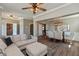 Open-concept living and dining area with wood floors, featuring a comfortable sofa and stylish dining set at 2325 Silver Rose Dr, Avon, IN 46123