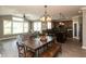 Open concept home featuring a dark wood dining table and chairs, leading into the kitchen and living room at 2325 Silver Rose Dr, Avon, IN 46123