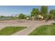 Community playground featuring swings, slides, and play structures, near a pond and surrounded by green spaces at 2325 Silver Rose Dr, Avon, IN 46123