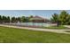 Community pool with ample seating and a covered shelter, surrounded by lush greenery and a secure fence at 2325 Silver Rose Dr, Avon, IN 46123