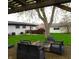 Backyard with patio, seating around fire pit, grassy yard, and partial view of the home at 2416 Depauw Rd, Indianapolis, IN 46227