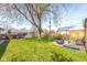 Grassy backyard featuring a fire pit, seating area, mature trees, and green grass at 2416 Depauw Rd, Indianapolis, IN 46227
