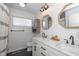 Bright bathroom featuring a dual sink vanity, wood-look mirrors, and modern fixtures at 2416 Depauw Rd, Indianapolis, IN 46227