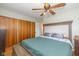 Bedroom featuring a large upholstered headboard, ceiling fan and wood floors at 2416 Depauw Rd, Indianapolis, IN 46227