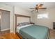 Bedroom with an upholstered headboard, ceiling fan and wood floors at 2416 Depauw Rd, Indianapolis, IN 46227