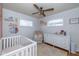 Sweet Bedroom features a crib, white dresser and chair at 2416 Depauw Rd, Indianapolis, IN 46227