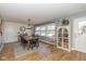 Bright dining room featuring wood table, black chairs, and a decorative hutch with glass doors at 2416 Depauw Rd, Indianapolis, IN 46227