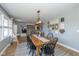 Open-concept dining room with wood table, black chairs, and a view into the living area at 2416 Depauw Rd, Indianapolis, IN 46227