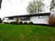 Inviting single-story home showcasing a painted brick exterior, complemented by manicured landscaping at 2416 Depauw Rd, Indianapolis, IN 46227