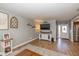 Bright living room with wood floors, television, and easy access to the front entrance at 2416 Depauw Rd, Indianapolis, IN 46227