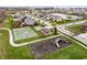 Community aerial view showcases a playground, basketball court, pond, and green spaces in a well-planned neighborhood at 2681 Pumpkin Patch Ln, Indianapolis, IN 46229