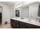 A well-lit bathroom featuring a double vanity, spacious mirror, and plentiful storage at 2681 Pumpkin Patch Ln, Indianapolis, IN 46229