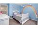 Bright bedroom with rainbow wall art, a white bed, and light blue walls at 2681 Pumpkin Patch Ln, Indianapolis, IN 46229