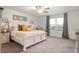 A cozy main bedroom featuring soft carpet, natural light, and a comfortable king bed at 2681 Pumpkin Patch Ln, Indianapolis, IN 46229
