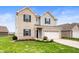 Well-maintained two-story home featuring a two-car garage and lush green lawn at 2681 Pumpkin Patch Ln, Indianapolis, IN 46229