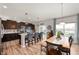 Open-concept kitchen featuring dark cabinetry, a center island, and dining area at 2681 Pumpkin Patch Ln, Indianapolis, IN 46229