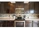 Well-equipped kitchen with stainless steel appliances, sleek black stovetop, and ample cabinet space at 2681 Pumpkin Patch Ln, Indianapolis, IN 46229