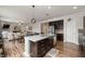 Kitchen island featuring a stainless steel sink, granite countertop, and dark wood cabinets at 2681 Pumpkin Patch Ln, Indianapolis, IN 46229