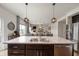 Kitchen island featuring a double sink and stainless steel dishwasher adjacent to a wide open living space at 2681 Pumpkin Patch Ln, Indianapolis, IN 46229