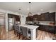 Stylish kitchen with dark wood cabinets, a granite island, and stainless steel appliances at 2681 Pumpkin Patch Ln, Indianapolis, IN 46229