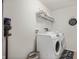 A functional laundry room is equipped with a washer, dryer, storage and folding area at 2681 Pumpkin Patch Ln, Indianapolis, IN 46229