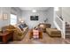 Inviting living room with comfortable seating, natural light, and easy access to stairs at 2681 Pumpkin Patch Ln, Indianapolis, IN 46229