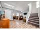 Spacious living room with hardwood floors, stairs, and comfortable seating area at 2681 Pumpkin Patch Ln, Indianapolis, IN 46229