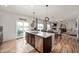 Open-concept living space with a modern kitchen island and access to an outdoor patio at 2681 Pumpkin Patch Ln, Indianapolis, IN 46229