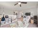 Spacious playroom with soft carpet, ceiling fan, natural light and a glider at 2681 Pumpkin Patch Ln, Indianapolis, IN 46229