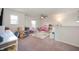 Bright playroom features neutral walls, ceiling fan, carpet, and a dedicated play area at 2681 Pumpkin Patch Ln, Indianapolis, IN 46229