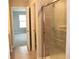 Modern bathroom featuring a tiled shower with glass doors and neutral-toned tile flooring at 2704 Grassy Br Dr, Whitestown, IN 46075