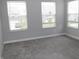Bright bedroom with carpet and three windows offering ample natural light at 2704 Grassy Br Dr, Whitestown, IN 46075