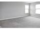 Spacious bedroom with plush carpet and two windows providing ample natural light at 2704 Grassy Br Dr, Whitestown, IN 46075