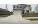 Charming two-story home with gray siding, a spacious driveway, and an attached two-car garage at 2704 Grassy Br Dr, Whitestown, IN 46075